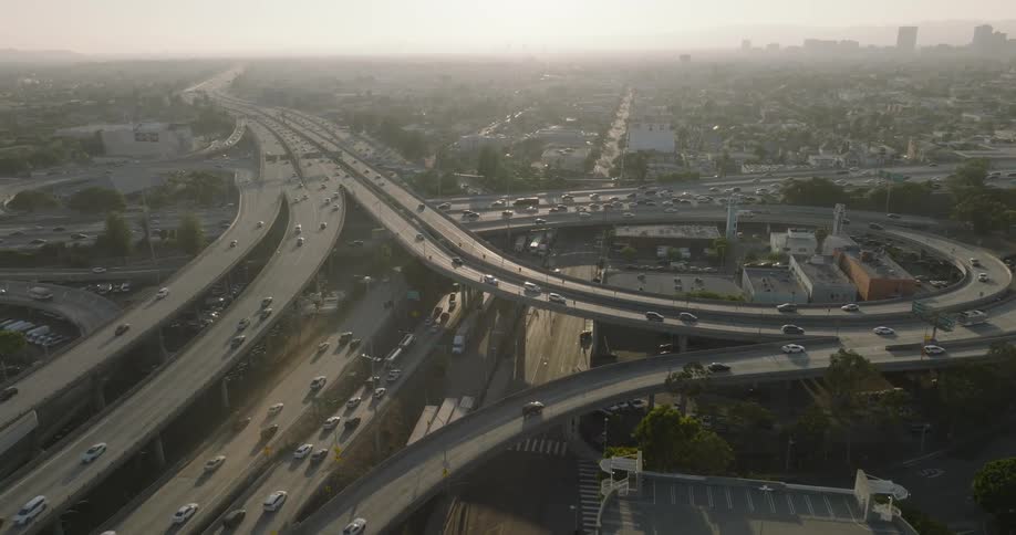 An aerial view of a complex highway interchange with multiple overpasses and vehicles traveling in various directions