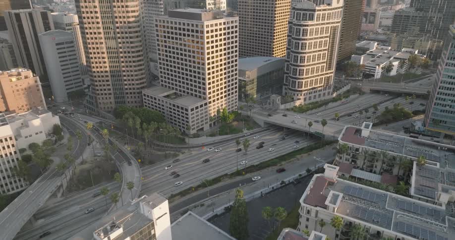An aerial view of a bustling los angeles street with many tall skyscrapers and busy traffic