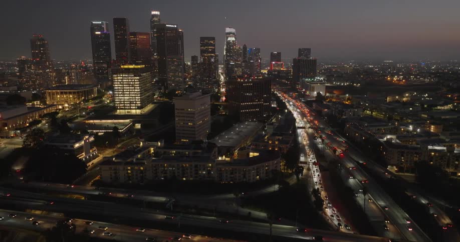 Aerial panorama of a metropolis with vehicle traffic and lights at night