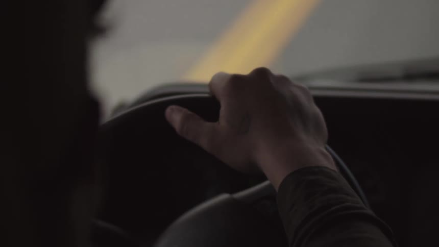 Someone's hands on a steering wheel as they drive