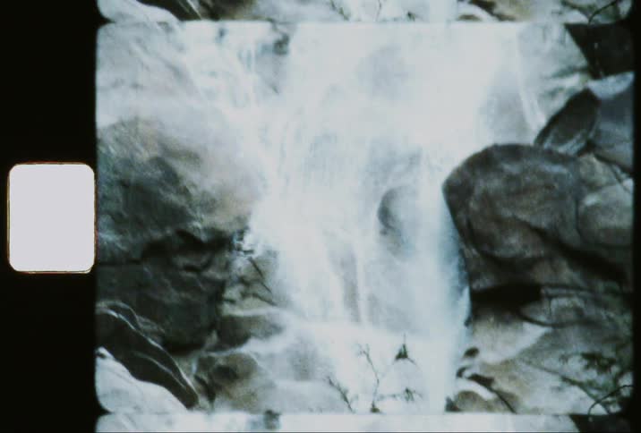 A rushing waterfall cascading down a rocky cliff