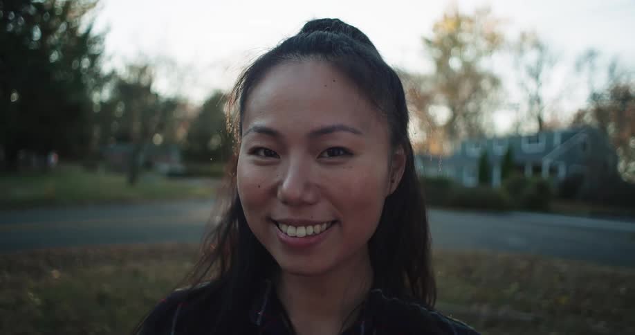 Portrait of a smiling woman outdoors in an urban neighborhood