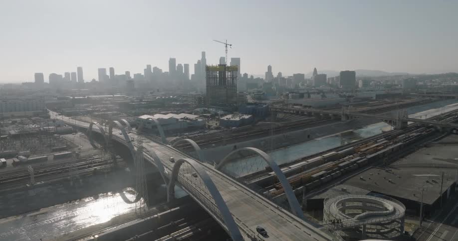 An aerial view of los angeles showcasing the 6th street viaduct against the backdrop of the city skyline
