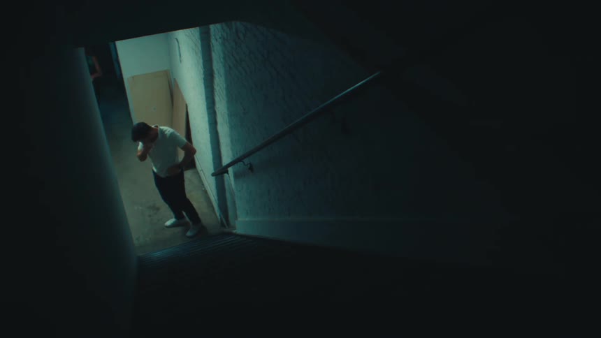 Man and woman talking next to a staircase