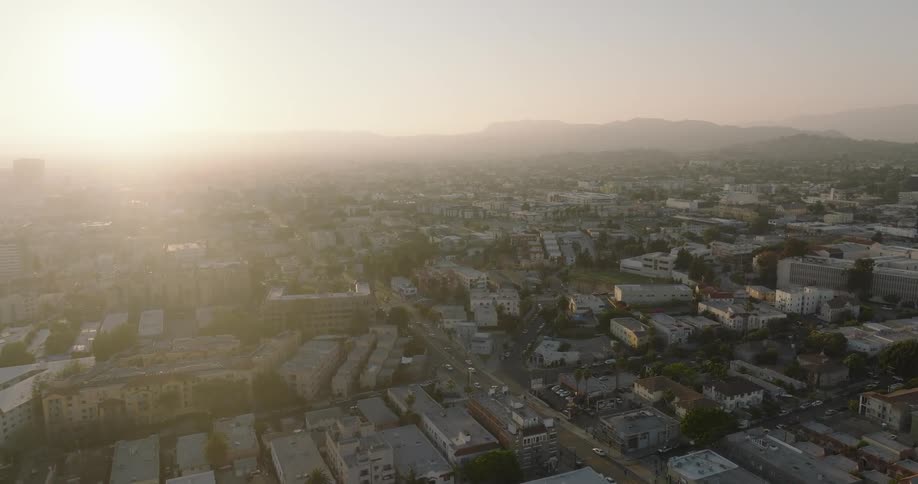 Aerial panorama of an urban city with mountains on the horizon