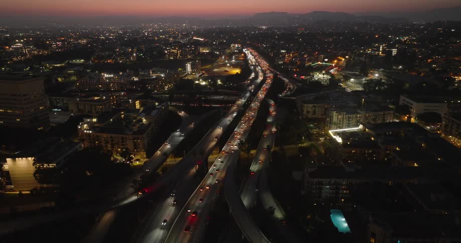 Cars on a highway winding through a city