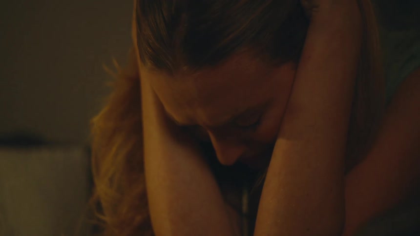 Woman sitting in a room crying