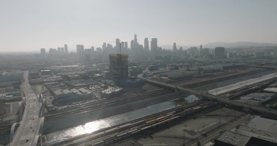 A hazy view of the los angeles skyline with several skyscrapers visible in the distance