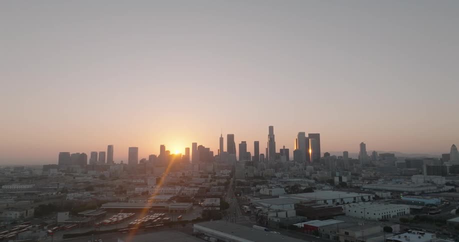 The los angeles skyline silhouetted against a vibrant sunset sky