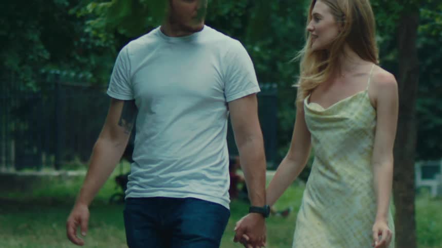 Couple outdoors walking together holding hands
