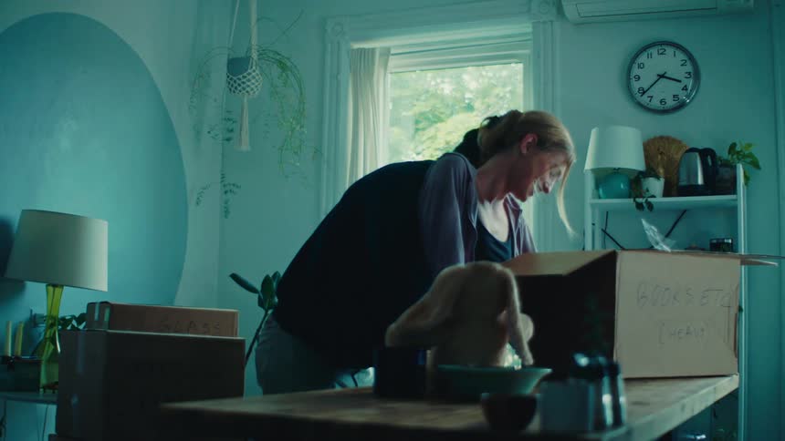 Man and woman in living room having fun together with moving boxes