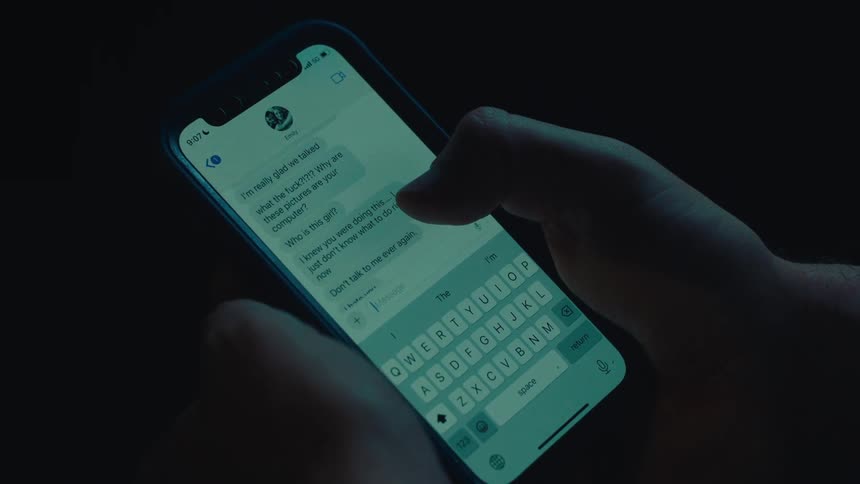 Close up of a pair of hands viewing messages on a smartphone
