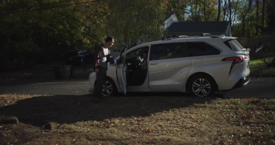 Man opening the door for a lady to get out of the car