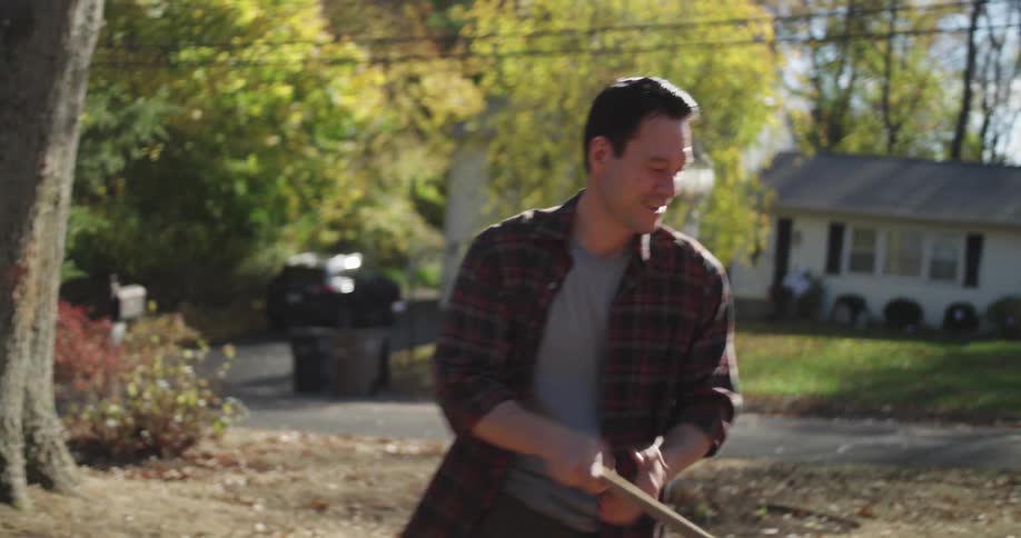 Man cleaning the yard of a house