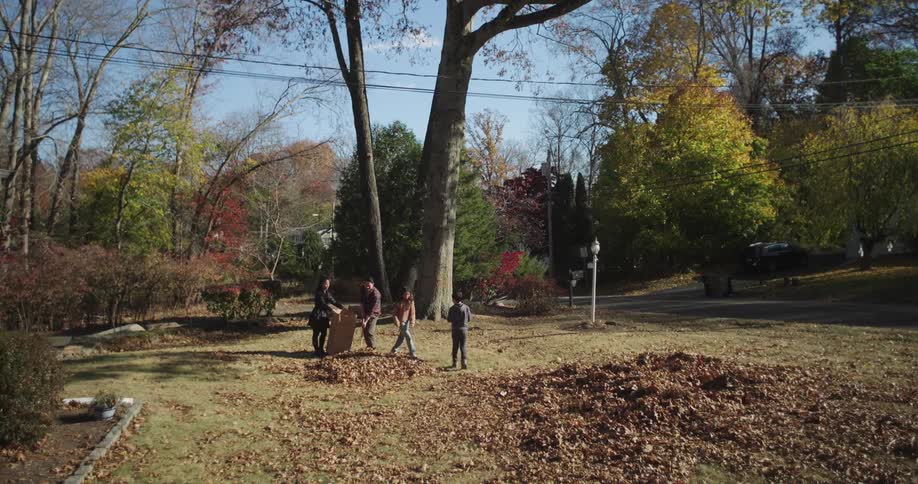Family including two children playing in a backyard