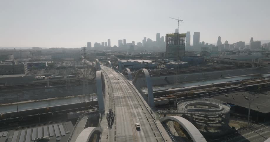 An aerial view of los angeles showcasing the 6th street viaduct against the backdrop of the city skyline