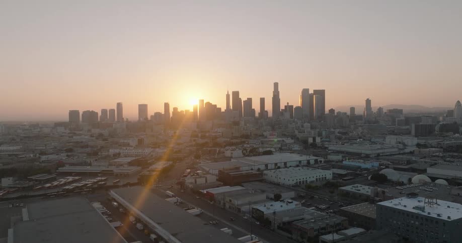 Aerial panorama of an urban city with skyscrapers on the horizon and sunrise