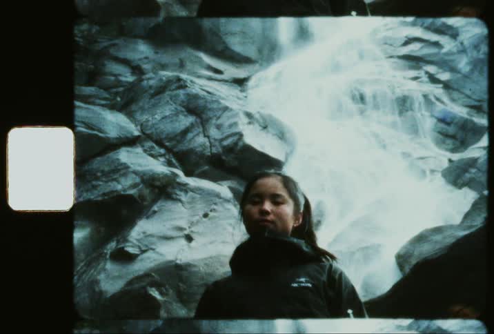 Woman next to a waterfall