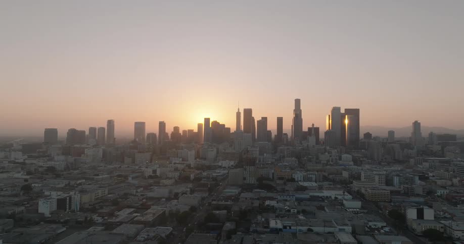 Aerial panorama of a metropolis with the sun rising on the horizon