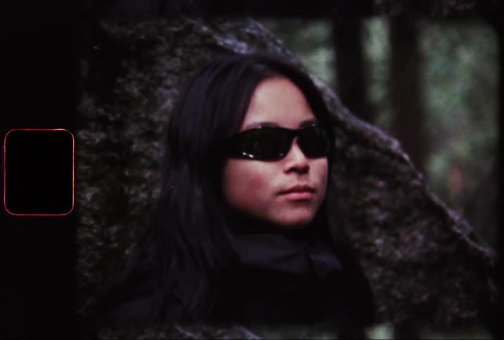 Portrait of a woman in the forest with dark sunglasses