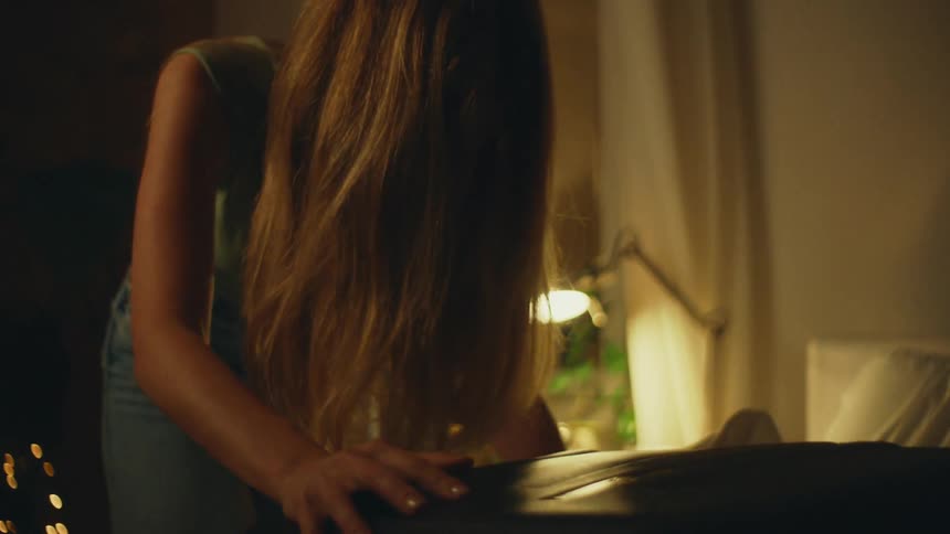 Crying blonde woman packing her bags in a room