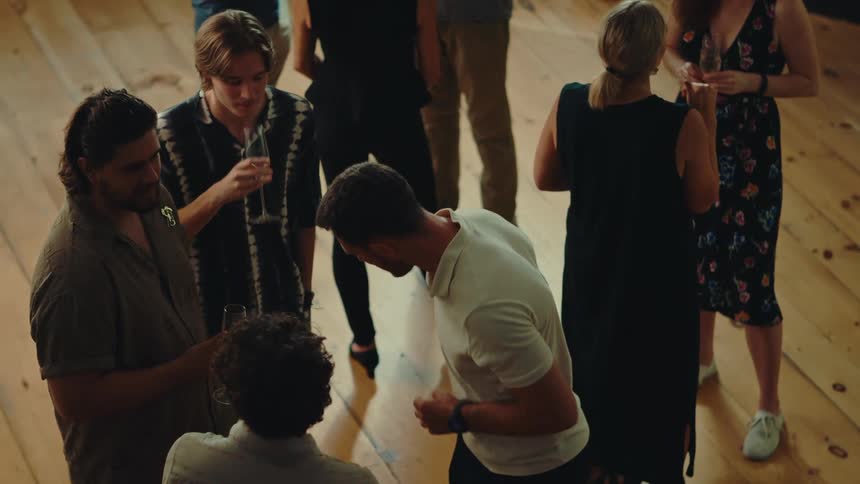 A group of people are socializing and drinking beverages