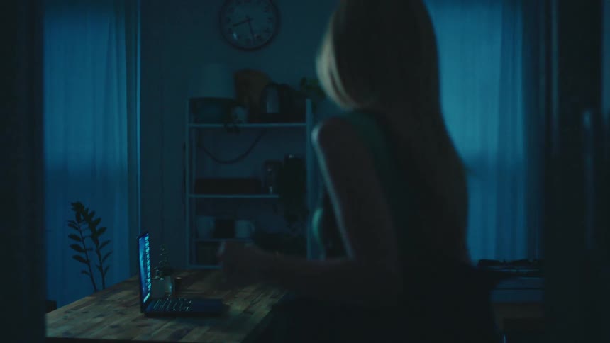 Woman browses on laptop before leaving her home