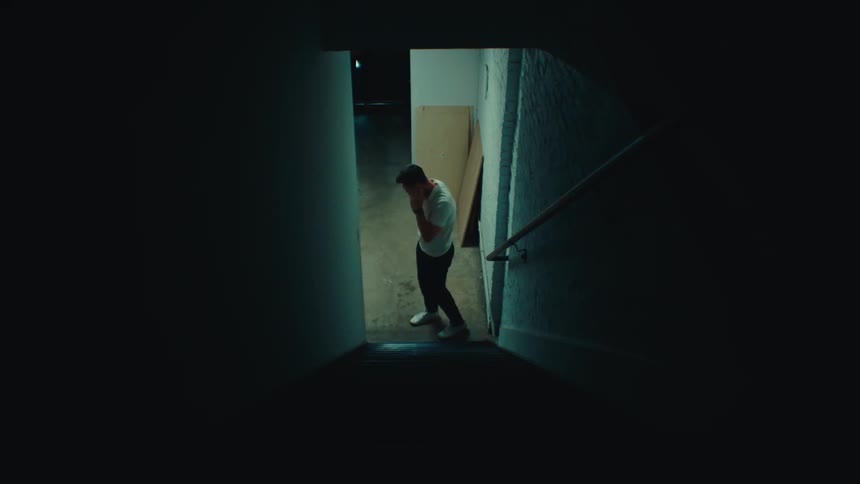 A clip of a man having a phone call while a woman approaches with surprise