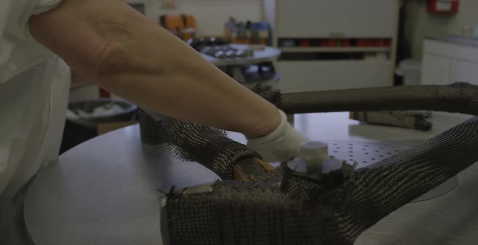 A person is working with a machine in a shop