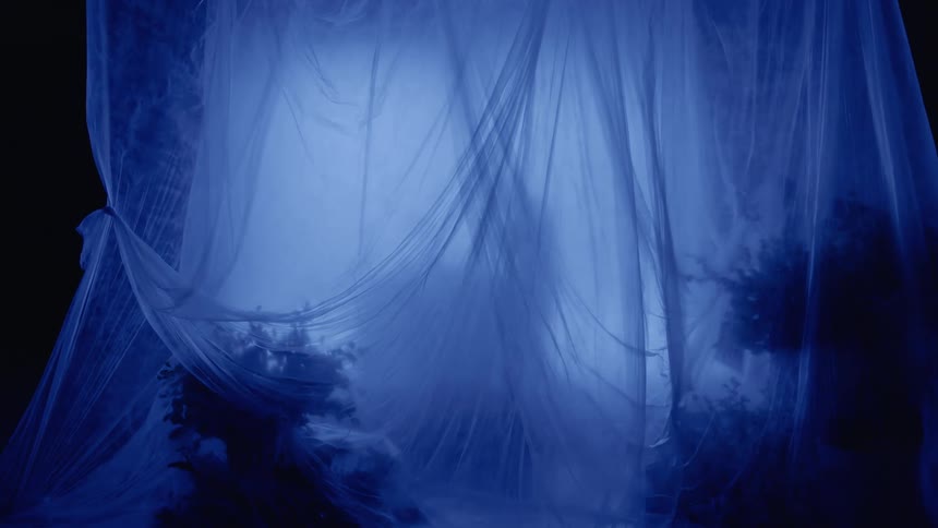 Scene of a dark room with curtains and a silhouette of a person