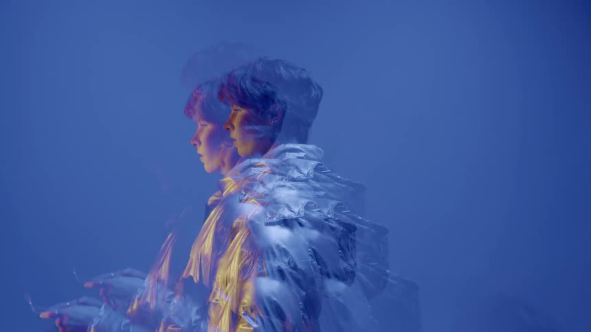 Woman in multiple exposures against a blue background