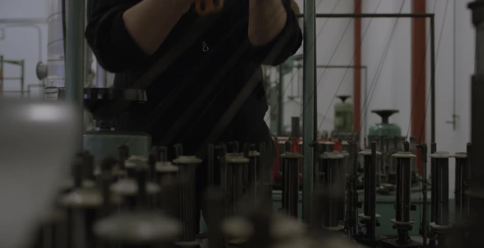 A person is working with a machine and thread