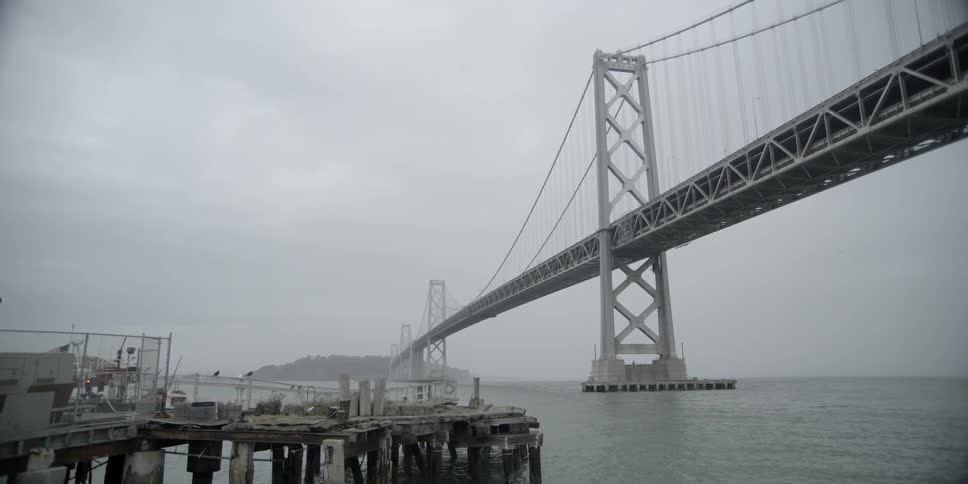 View of a large bridge going over water into a small peninsula