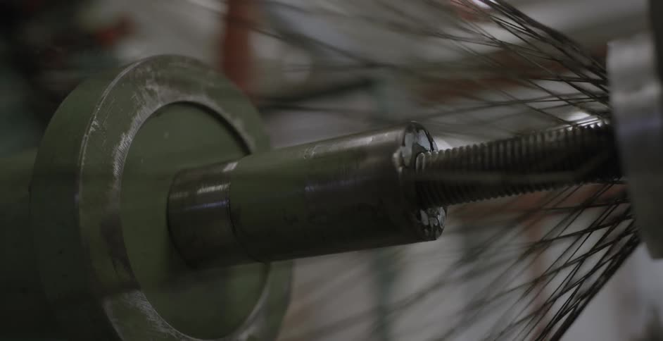 Threads being woven together by a machine