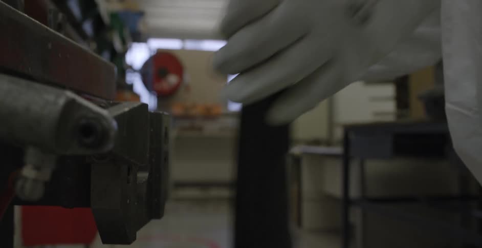A person is working with tools in a shop