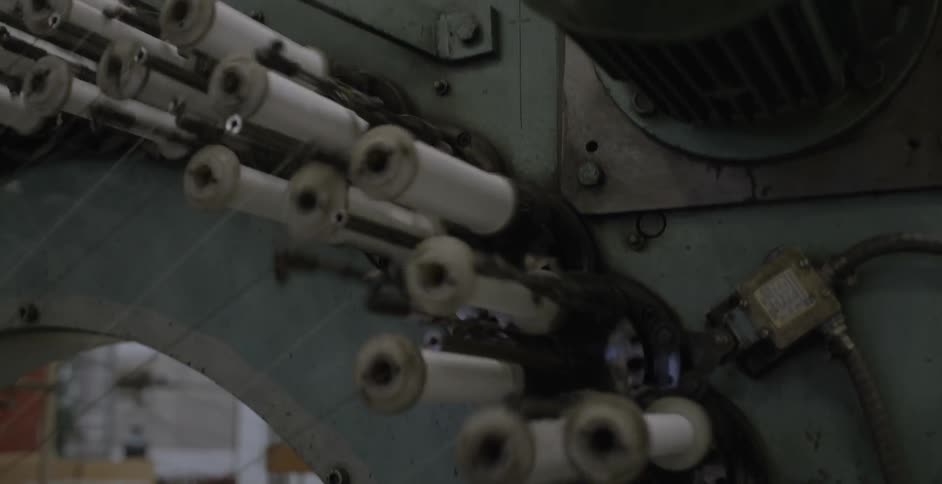 A machine is working pulling on thread
