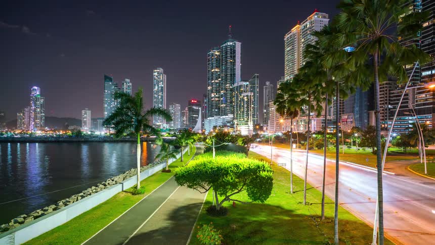Metropolises at night by the sea and with modern skyscrapers