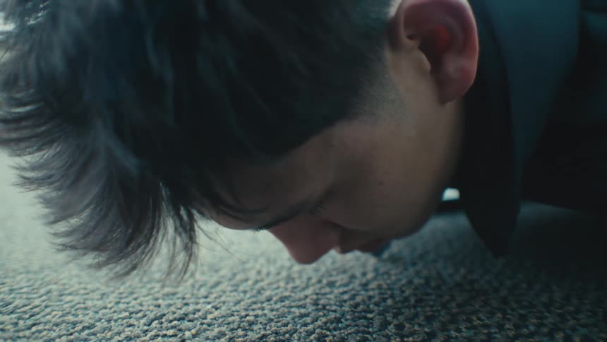Male laying directly on the carpet in a room