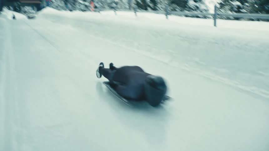 A footage of a person sliding through the ice slide way