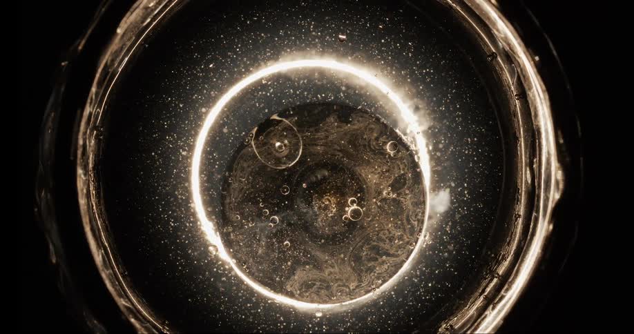 Abstract closeup on a dense illuminated liquid