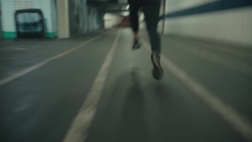 Legs of a person running in an indoor space