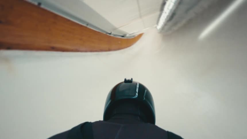 Point of view of luge rider going down luge track at very high speed