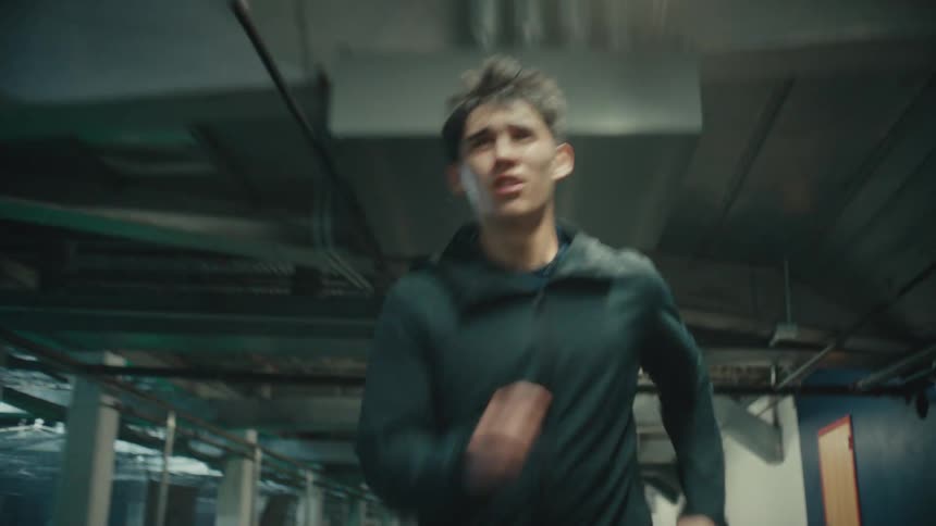 Man running with facial expression of effort