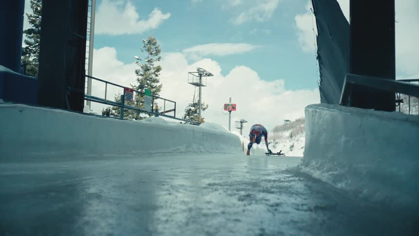 A skeleton racer speeds down an icy track