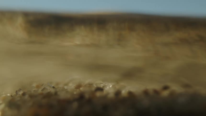 A closed up clip of sea sand and stones