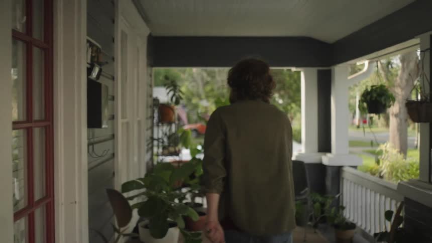 Angry male walking around porch looking in and banging on glass door