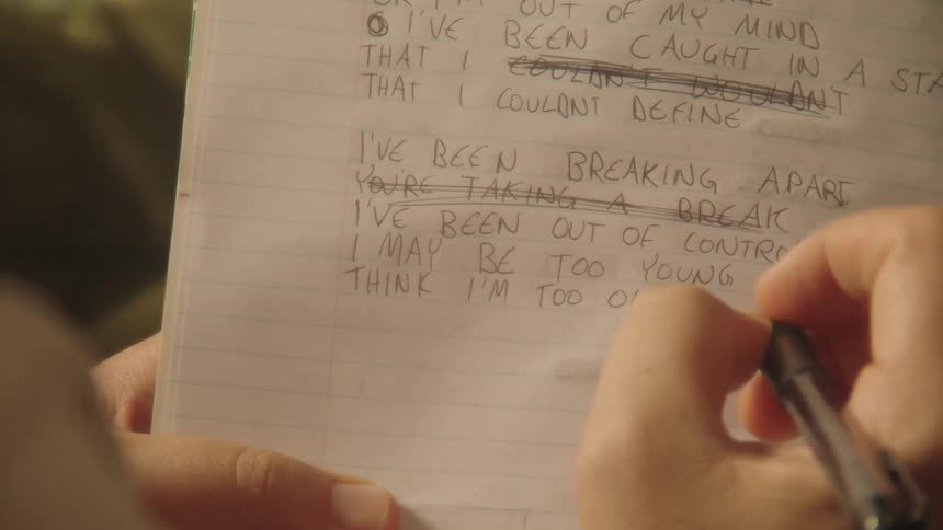 Hand with a pen writing in a notebook