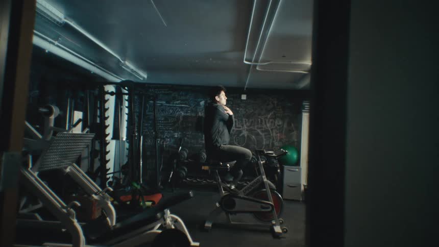 Man doing cardio on an exercise bike in a gym
