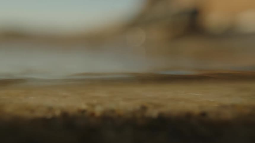 Time lapse of water flowing rapidly over sand