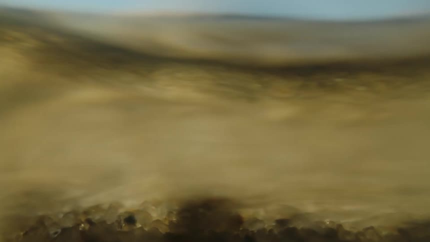 Water flowing over a surface with pebbles and sand